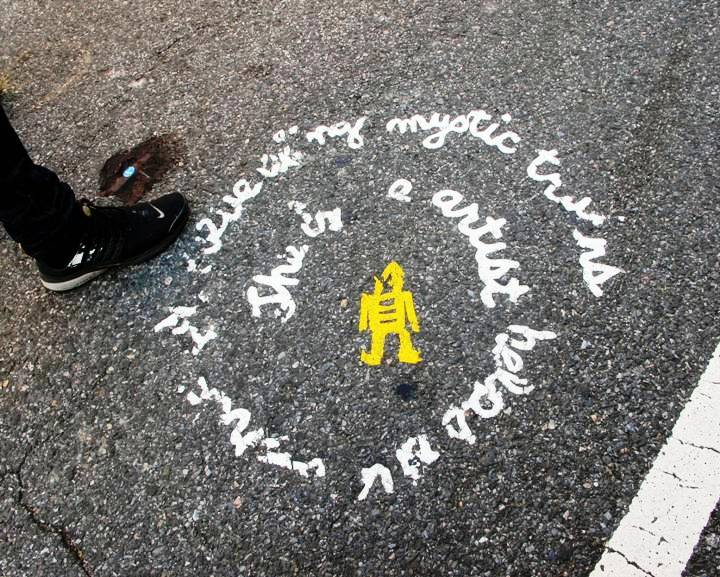"stikman street art on pavement"